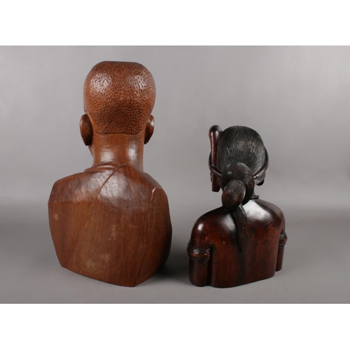 124 - An African caved wooden head and shoulder bust of a man from one single piece of wood. Height 43cm, ... 