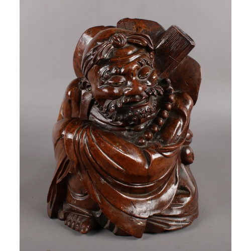 126 - A carved Chinese hardwood figure (approximately 30cm).