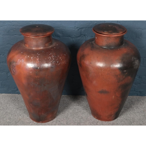 410 - Two large lidded terracotta baluster shaped urns. (80cm tall)