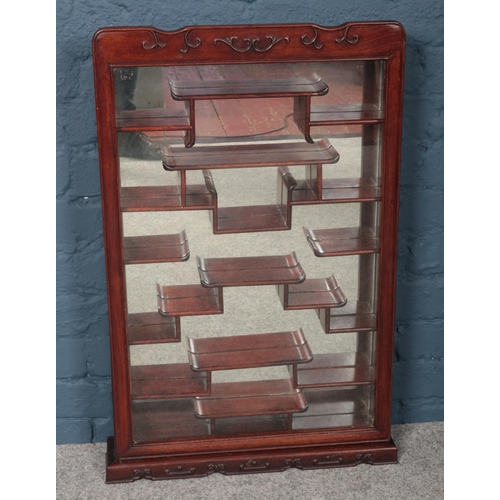 430 - A glazed Chinese hardwood wall mounting display cabinet, with key.