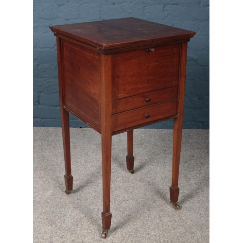 433 - A Victorian mahogany work/sewing box raised on tapering supports.