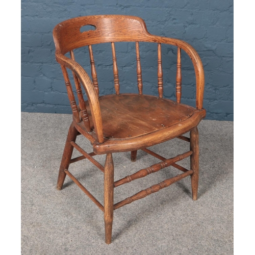 435 - An oak captain's chair with turned supports.