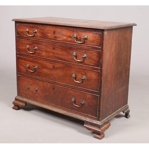 443 - A George III mahogany chest of four graduated drawers. Oak lined, with bronze drop handles and raise... 