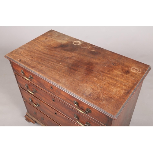 443 - A George III mahogany chest of four graduated drawers. Oak lined, with bronze drop handles and raise... 