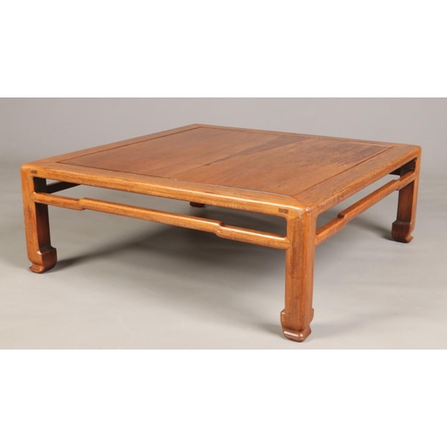 444 - An early 20th century Chinese carved hardwood square low table, 89cm square, 32cm high.