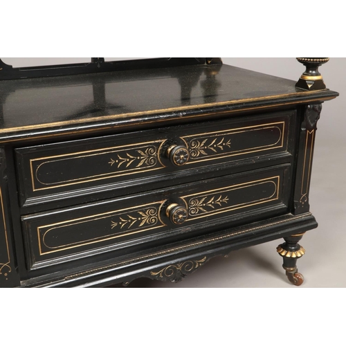 445 - A Victorian ebonized and parcel gilt two tier dumb waiter. With reeded column supports, two drawers ... 