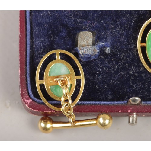 298 - A cased pair of Chinese 18ct gold cuff links with ovoid jadette tablet. 7.34g.