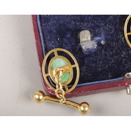 298 - A cased pair of Chinese 18ct gold cuff links with ovoid jadette tablet. 7.34g.