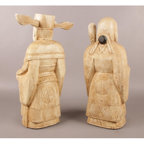 118 - Two Oriental carved & painted wooden figures. H: 38cm, W: 15cm.
