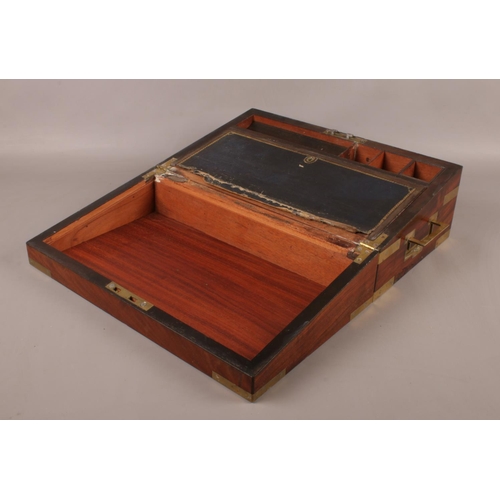 141 - A Victorian Mahogany campaign writing slope, with brass mounts to corners and straps and two handles... 