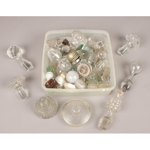 69 - A box of mostly glass stoppers.