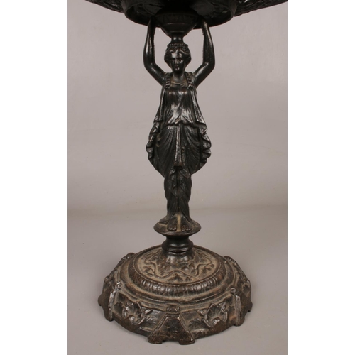 88 - A cast iron 'Lady Tessa' centrepiece. Decorated in a classical style.  H: 34cm, W: 29cm.