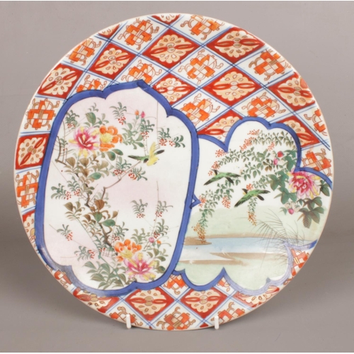 98 - A Japanese Meiji period Imari plate. (27cm diameter)