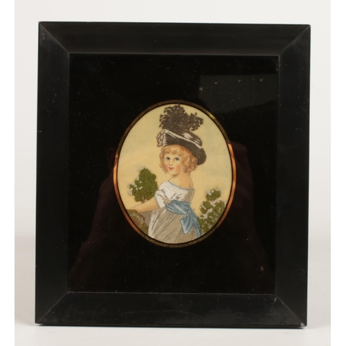 32 - A pair of 19th Century ebony framed oval silk needlepoint embroidered oval portraits of young childr... 