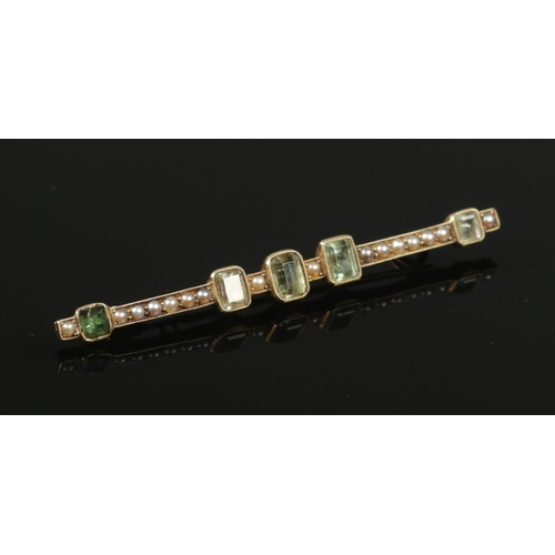 401 - A gold emerald and seed pearl bar brooch. Unmarked. (4.6g).