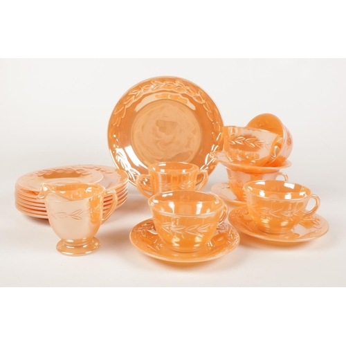 198 - A collection of  Fire King oven ware. In orange lustre finish. Cups/ saucers, side plates, milk jug ... 