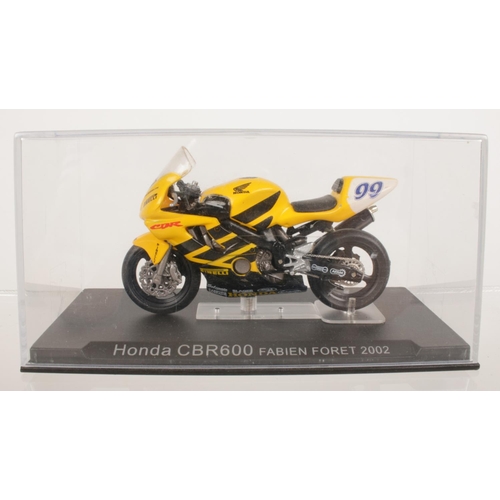 201 - A collection of seven boxed diecast models of motorbikes - comprising of a Yamaha RD05 250 Phil Read... 