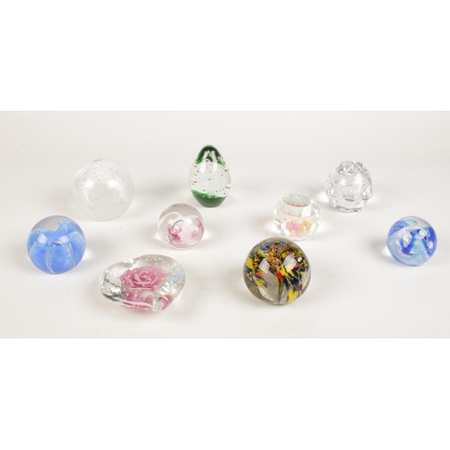 216 - A group of glass paper weights.