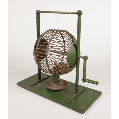 217 - A vintage metal Bingo machine, with a quantity of wooden balls. (Height approximately 35cm).