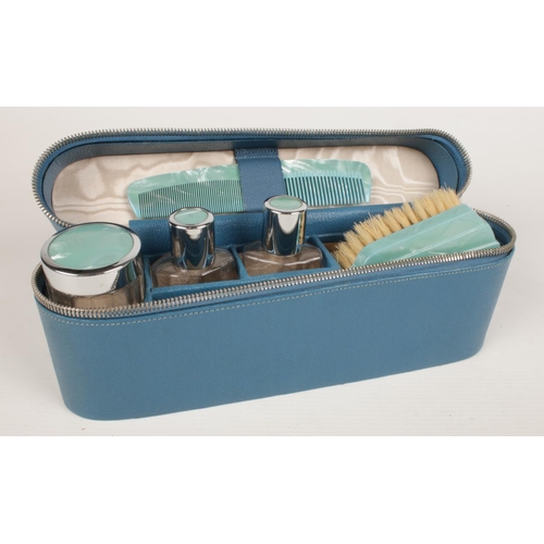 227 - A cased art deco style travel vanity set - comprising of a brush, comb, two glass bottles & pot. 
Ca... 
