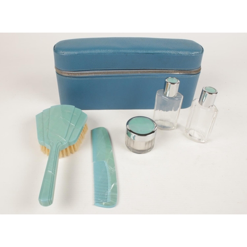 227 - A cased art deco style travel vanity set - comprising of a brush, comb, two glass bottles & pot. 
Ca... 