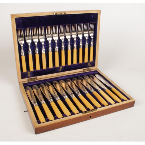 233 - A cased twenty four piece fish knife set. Comprising of silver collars assayed in Sheffield 1907 by ... 