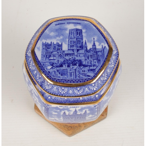 243 - A 'Wade' blue and white lidded hexagonal tea caddie for Ringtons tea. Decorated with various cathedr... 