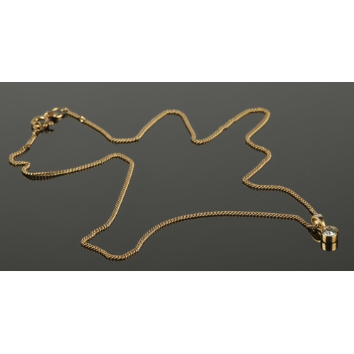 396 - An 18ct gold necklace and drop pendant set with a single diamond. Chain length approximately 40cm. (... 