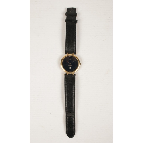 399 - A Givenchy Quartz Men's wrist watch with leather strap. Has a black face with date aperture.