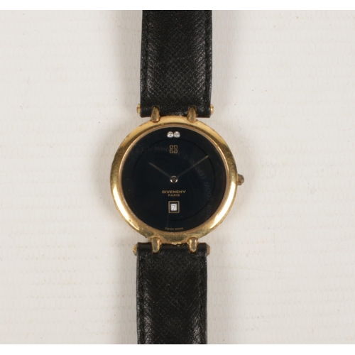 399 - A Givenchy Quartz Men's wrist watch with leather strap. Has a black face with date aperture.