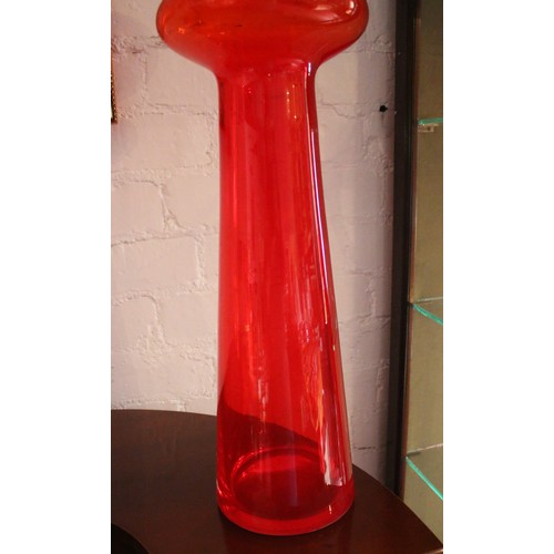 219 - A large decorative red glass vase. Handmade in Poland. (70cm).