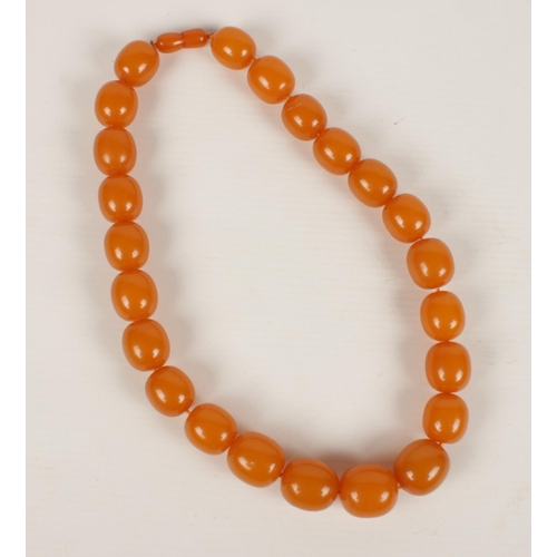 594 - A spice Amber necklace, comprising of 25 graduated beads with screw cup fastener, 53 cm long, widest... 