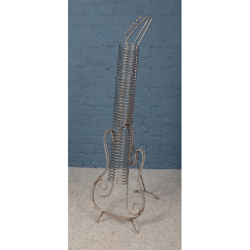 528 - A decorative metal CD rack in the shape of a guitar.