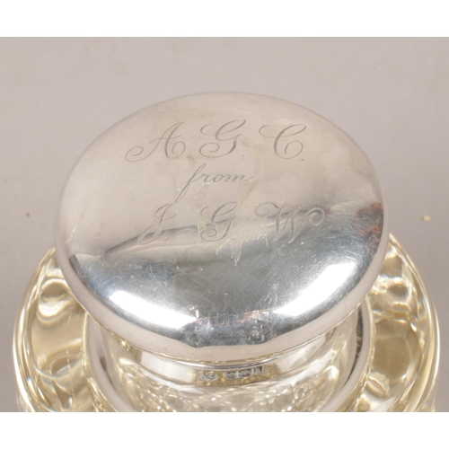 461 - A silver topped glass ink well. Assayed Sheffield 1902 by Boardman, Glossop & Co Ltd.