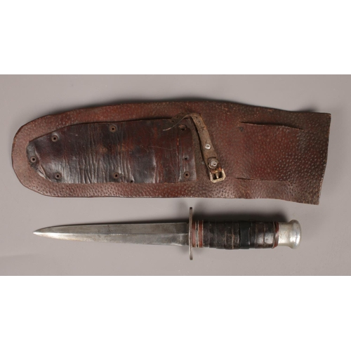 464 - A vintage dagger with leather sheath.