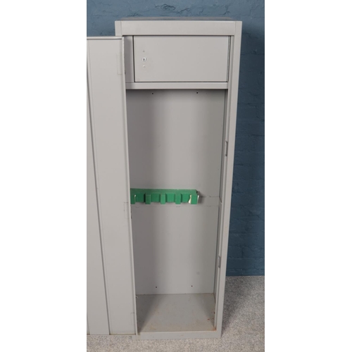 537 - A grey steel gun cabinet. Dual locking with interior lockable compartment. (Height 153cm, Width 46cm... 