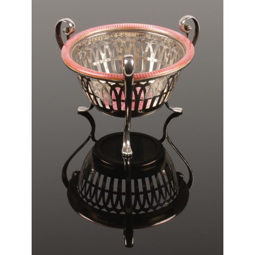 469 - An early 20th century white metal basked. Raised on three scrolling feet and decorated with pink gui... 