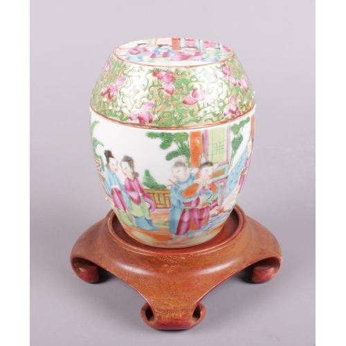 420 - A Chinese famille rose barrel shaped jar decorated with figures.