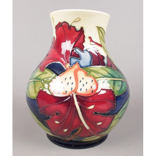 441 - A Moorcroft vase with painted lilies - 'Simeon' by Phillip Gibson. H: 16cm. (Unboxed).