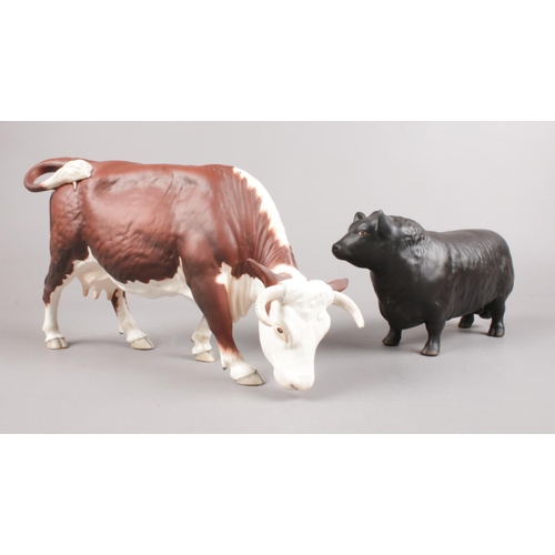 442 - Two Beswick cattle figures. Aberdeen Angus Bull (Matt) & Brown & White horned Cow. (original boxes)