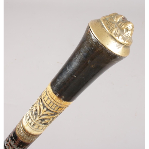 447 - NOT AS CATALOGUED A Victorian ebonised sword stick. With brass lion mask pommel.