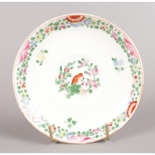 457 - A Royal Worcester hand-painted small bowl and saucer. Decorated in the Worcester parrot pattern with... 