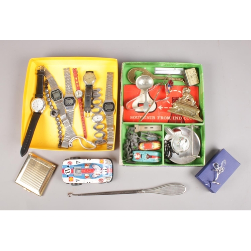 63 - Two boxes of collectables. Includes wristwatches, silver handle button hook, tin plate cars, orienta... 