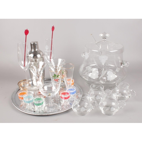 67 - A collection of mostly glassware. Includes etched glass punch bowl and glasses, cocktail shaker, Bab... 