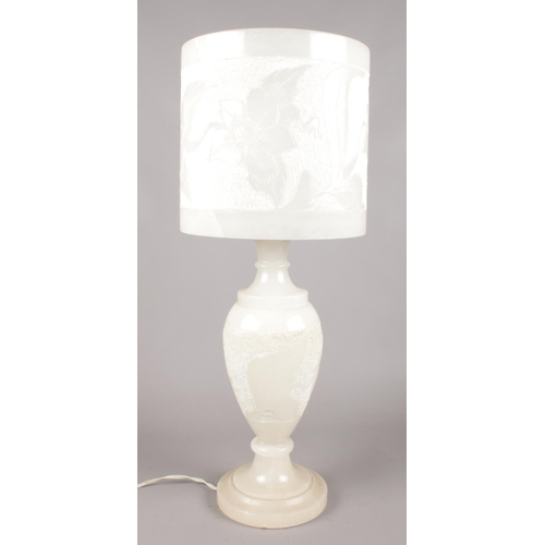 68 - A large alabaster table lamp with floral decoration. (Height 59cm).