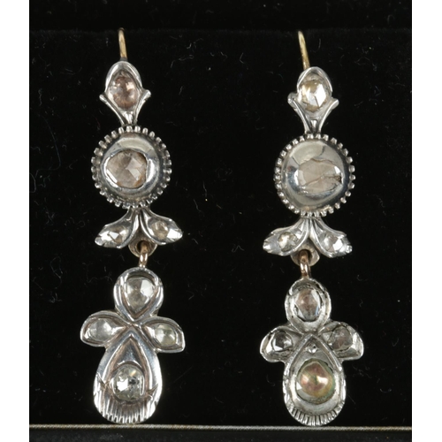 561 - A pair of antique white metal and diamond drop earrings.