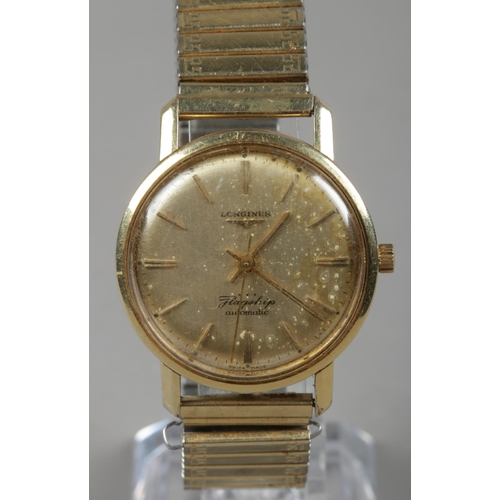 565 - A gents Longines Flagship automatic wristwatch. With baton markers on later yellow metal expanding s... 