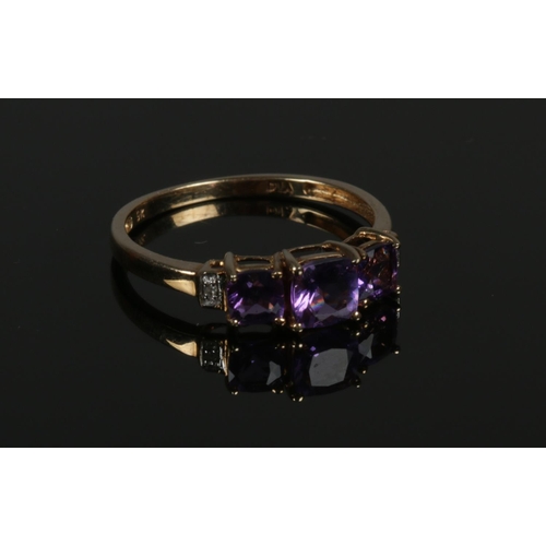 570 - A 9ct yellow gold Amethyst/Diamond ring, size P. Weight 1.54g, largest Amethyst 5mm.