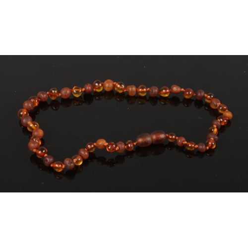 601 - A cognac amber part polished necklace with screw cup fastener 32cm long