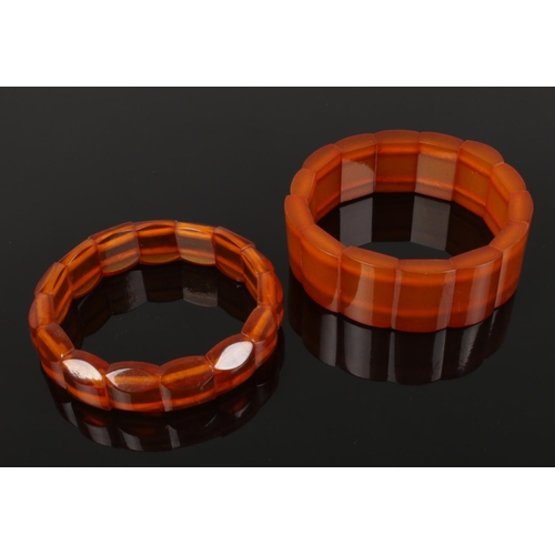 604 - Two bronze amber polished block elasticated bracelets the widest is 20cm